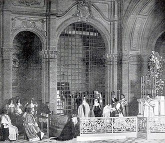 elaborate stage set with large cast, with a nun centre stage