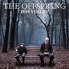 The album cover depicts a boy sitting on a bench in a forest on the right side looking upwards alongside an old man on the left side who is looking towards the camera. The words "The Offspring" and "Days Go By" are on the top and are in capital letters.