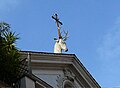 The stag-and-cross symbol of St. Eustace sits atop his church in Rome.