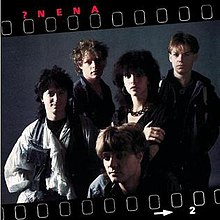 A low-light photo of the band framed in a filmstrip with the album title and band name in the top-left corner in red.