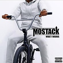 An image of a man wearing a white hoodie and sweatpants on a bicycle.
