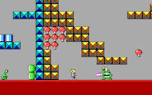 Side view of Commander Keen facing a Martian Garg enemy, surrounded by a structure composed of square blocks.
