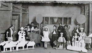 photograph of a stage filled with children costumed as toys