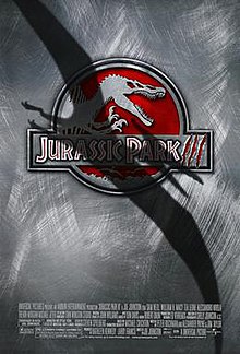 Film poster with a logo at the center of a skeleton of a Spinosaurus, with its mouth wide open and hands lifted. The logo's background is red, and right below it is the film's title. A shadow covers a large portion of the film poster in the shape of a flying Pteranodon. At the bottom of the image are the credits and release date.