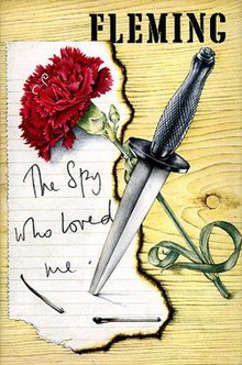 Book cover showing a piece of paper with the words "The Spy Who Loved Me"; these are overlain with a red rose and a commando dagger. At the top is the name "Fleming".