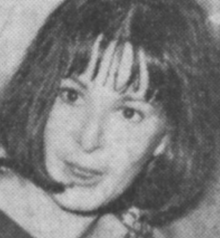 A young white woman with dark hair cut in a blunt bob with bangs
