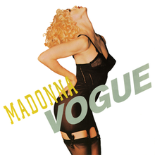 Madonna poses with her head leaning back, wearing a black corset.
