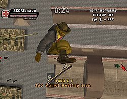 A dark-skinned man wearing a fedora and heavy jacket performs a skate trick about fifty feet above a halfpipe, having built up momentum by skating in it. Russian military tanks and a few people are standing off to the sidelines.
