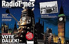 A gatefold magazine cover, depicting a nighttime scene with four gold Daleks in the foreground, the railing of a bridge in the midground, and the Perpendicular Gothic towers of the Houses of Parliament and Big Ben in the background. The left half of the image contains the text "Radio Times" in the top, and "VOTE DALEK!" in the lower left. A small black-and-white photograph is superimposed on the upper left of the right side of the image; that photograph, taken from a slightly different angle, shows four Daleks crossing the same bridge, with the same building in the background.