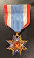 A membership medal worn by Brevet Col. Perrin V. Fox of the 1st Michigan Engineers. His son later wore this medal as a descendant member. Descendant members wore a ribbon with a blue stripe in the center until 1935, when all members were entitled to use a red-center ribbon.