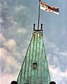 Queen Elizabeth II's personal Canadian flag, featuring the Royal Banner of Scotland in the quartered coat contained in the first and second divisions, flying over the Peace Tower, Ottawa.