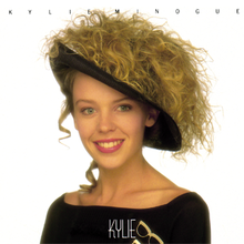 Minogue smiling and wearing a hat of hair