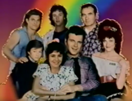 The show's characters posing for a group photo in front of a rainbow background