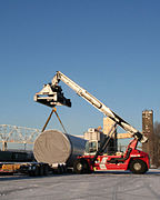 Project cargo is loaded onto a trailer by a reach stacker