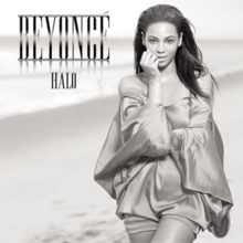 Grayscale portrait of Beyoncé, who is standing next to a beach. She is wearing a metallic short dress. She crosses her left arm across her body while the other arm rests against her face. Next to her image, appear the words "Beyoncé" and "Halo" in capital letters.