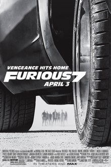 A close up of a car on a desert, with a group of people looking at it from a distance. Above the film's title, the tagline reads "VENGEANCE HITS HOME".