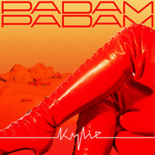 A pair of thigh-high red boots in front of a desert landscape and yellow sky, with the song title at the top in red block letters and "Kylie" at the bottom in white, with its letters joined by a white line