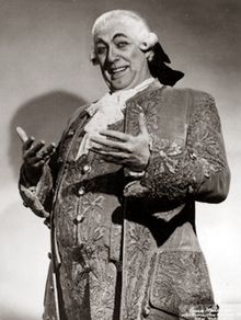 clean shaven white man, heavily padded to look fat, in 18th-century wig and costume