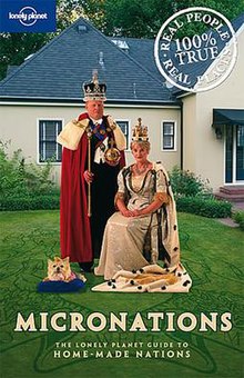 Two people—one sitting and the other standing—and a dog, all wearing regalia, on a lawn in-front of a suburban house. Below the people and still fronting the lawn is the title in black-outlined vanilla white text, in all capitals: "Micronations: The Lonely Planet Guide to Home-made nations". In the top left corner is the logo of Lonely Planet—the titular white wordmark intersecting a circle in the middle—fronting a blue rectangular background, and in the top right is a white circular stamp stating "100% True" in the centre; the text surrounding the circle reads "Real People" (top) and "Real Places" (bottom).