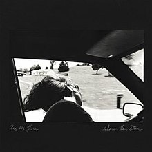 A black-and-white image of a seated woman in sunglasses looking out the open window of a moving car. Handwritten text underneath reads "Are We There" on the bottom left and "Sharon Van Etten" on the bottom right.