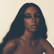 A photo of Knowles' face with a mask across her eyes