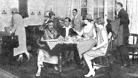 indoor scene with four people seated round a table, arguing, oblivious to the four people tiptoeing past them towards the door