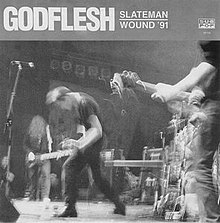 A 1991 black-and-white photograph of Godflesh performing live in support of Nirvana