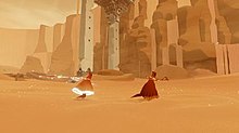 A red-robed figure runs through the sand in front of some stone ruins, accompanies by another figure. The trailing figure's robe and scarf are glowing.