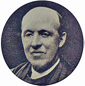 head of a middle-aged, balding man in clerical clothes