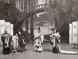 stage scene set in a grand Japanese garden with five European performers in Japanese make-up and costume